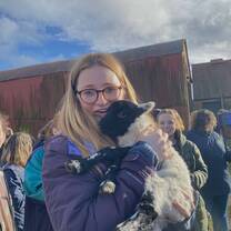 Holding a baby lamb at a wool farm we visited on Arcadia Abroad's Highlands Weekend