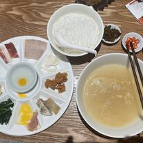 This is "crossing the bridge rice noodles" -- perhaps THE classic Yunnnan food (you mix everything together). This restaurant around the corner from school.