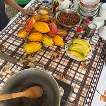 Learning to process cocoa beans by a local family to make chocolate 