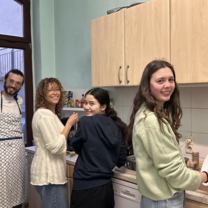 Volunteers and Excellence Center member preparing for meal