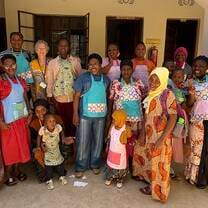 Students showing off the children’s aprons we made. 