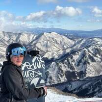 Me with my snowboard with the mountain view