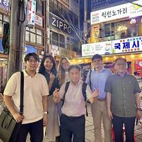 Interns, CEO, and financial partners after a company dinner