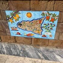 On a wall in front of the sea
