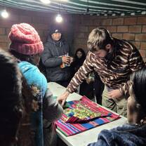 Participating in Aymaran traditional ritual giving thanks to Pachamama
