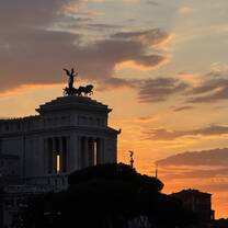 The sunset view from Via dei Fori Imperiali over Monumento a Vittorio Emanuele II