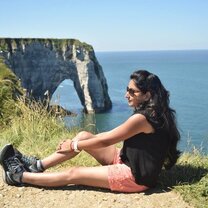 A woman posing in front of cliffs on the coast of France!