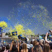 blue and yellow confetti in the air above a crowd of people