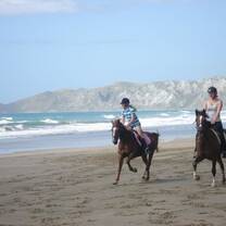 Farmstay girl taking the families daughter for a beach ride