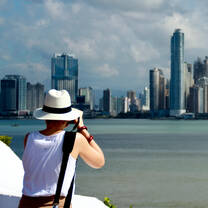 Tourist taking photos of Panama City Skyline from La Cinta Costera