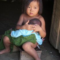 Hilltribe village in Laos, learning how to hold your baby brother