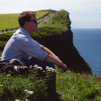 A student on an excursion to the Cliffs of Moher.