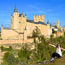 A student poses outside El Alcazar castle in Segovia
