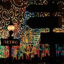 Metro sign at night, with lights all around