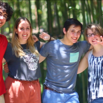 4 students with their arms around each other