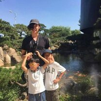 summer holiday with Chinese kids girl with two kids in front of a lake