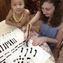 teacher writing chinese with a kid