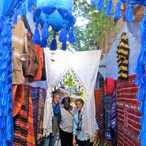 Students standing between walls lined with fabric 