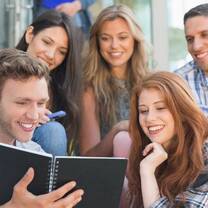 YCC Shanghai students smiling & reading a book