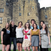 students posting at a castle