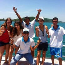 group in front of ocean wearing matching shirts