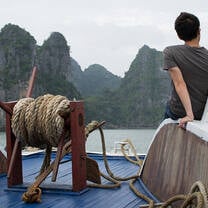 two people sitting on dock overlooking lake