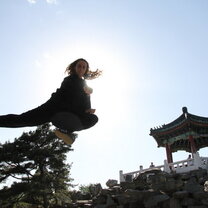 Academic Explorers student practicing a flying jump kick