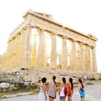 A group of female students view the Parthenon at sunset