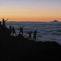 students hiking in new zealand sunset