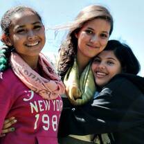 A group of study abroad students embracing each other