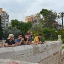 people in park leaning up on wall