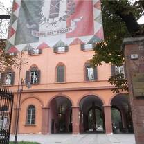 orange historic building with large flag sign above it 