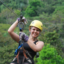 Student zip lining through the rainforest