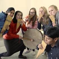 Apulaya students playing Andean panpipes