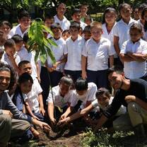 two of 2016's volunteers with the students & their new cacao tree