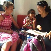 A volunteer reading to a local child 