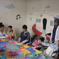 A volunteer with a group of children at Annour