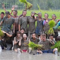 group of students covered in mud posing in Thailand