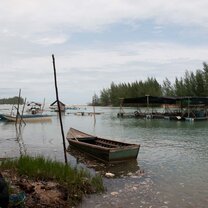 boat in water with trees in background in Thailand