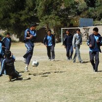 Students playing football during their break time Students playing football during their break time
