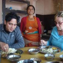 Volunteer having Nepali meal with the Nepali host family