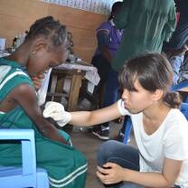 Volunteer taken care of the sick school kid