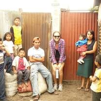 A volunteer with a family she helped build a home for