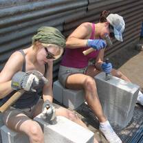 Volunteers working with cinder blocks