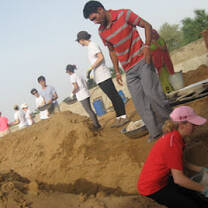 Volunteers build a boarding house for students
