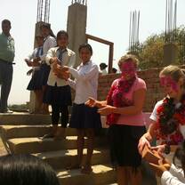 Volunteers and local students moving bricks