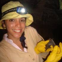 A volunteer shows off the bat she has just taken the biometrics for.