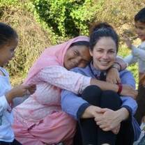 Volunteer plays with children at daycare