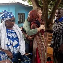 Volunteer hugging local child