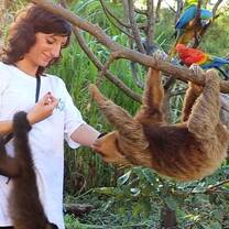 A woman helping a monkey in Peru